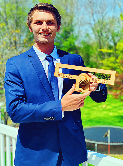 UW-Stout graduate Weston Knutson with a prototype of the Hitch N’ Go.