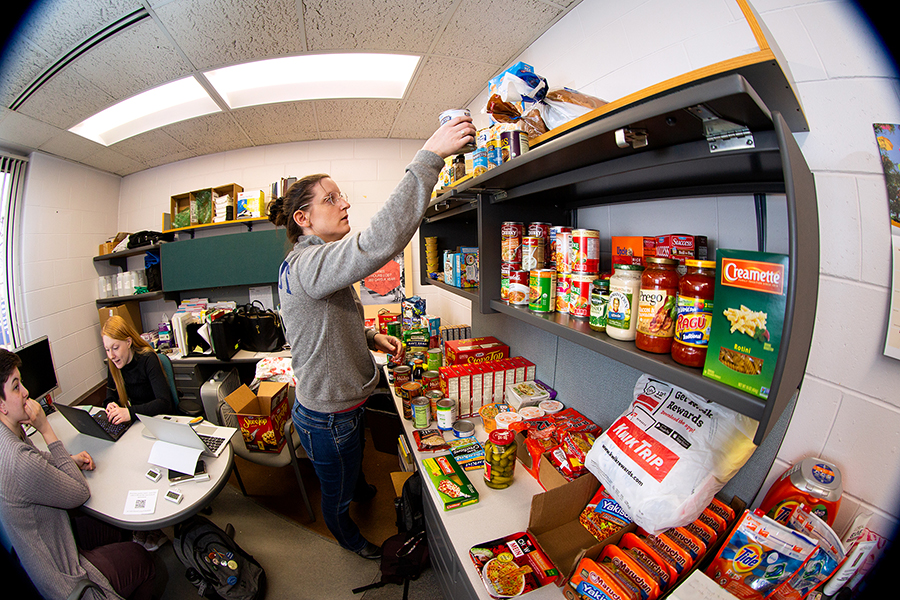 Sarah Snyder, UW-Stout residence life coordinator, stocks shelves at Helping Hand food plus pantry in the University Services building at UW-Stout.