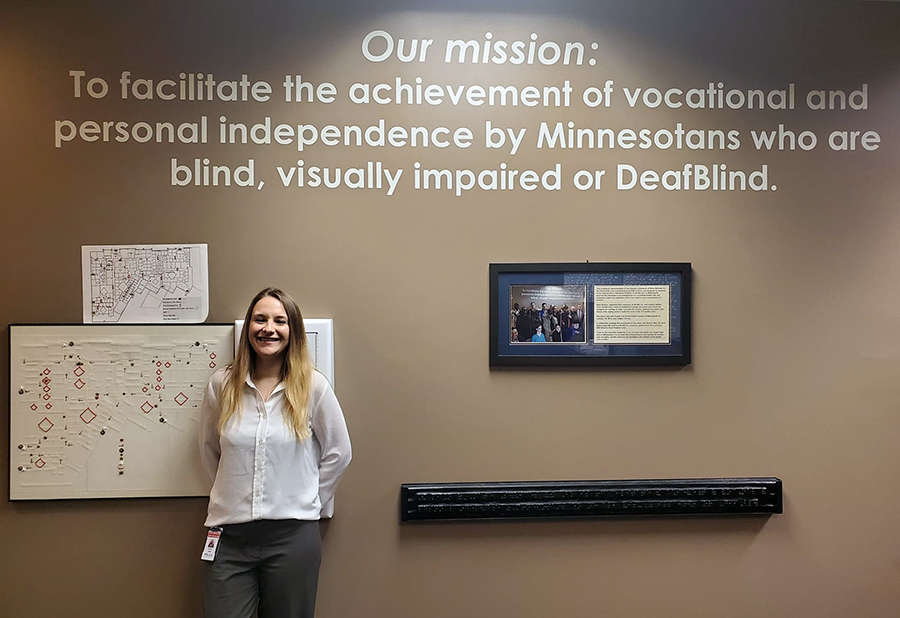 Natasha Jerde, who has two degrees in rehabilitation from UW-Stout, stands by the Minnesota State Services for the Blind mission statement in St. Paul.