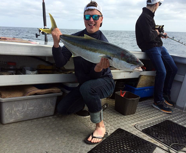 Klobucar shows off a kingfish he caught while in New Zealand.