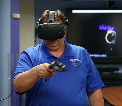 Kevin W. Tharp uses a virtual reality headset.