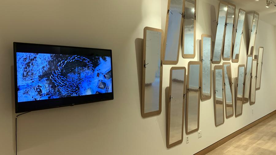 Mirror shields made by UW-Stout art and design students are part of the Furlong Gallery exhibit. At left is a video showing similar shields in use at a protest.