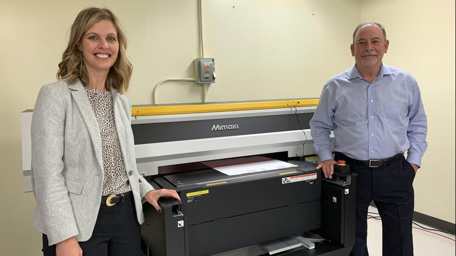 Michelle Hansen, left, and Rick Luftman, vice president of sales and marketing for Green Bay Packaging, viewed the new Mimaki printer that was part of a $180,000 donation to UW-Stout.