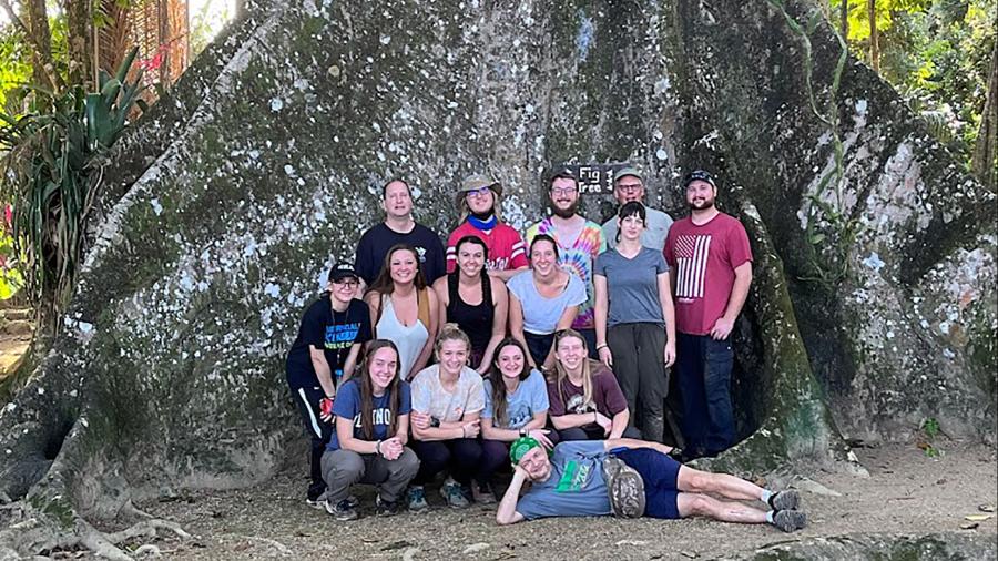 UW-Stout students in the Natural History of the Neotropics course, along with professors Mike Bessert, front on ground, and Steve Nold, second from right in back, stop in front of a giant strangler fig tree while in Belize in January.