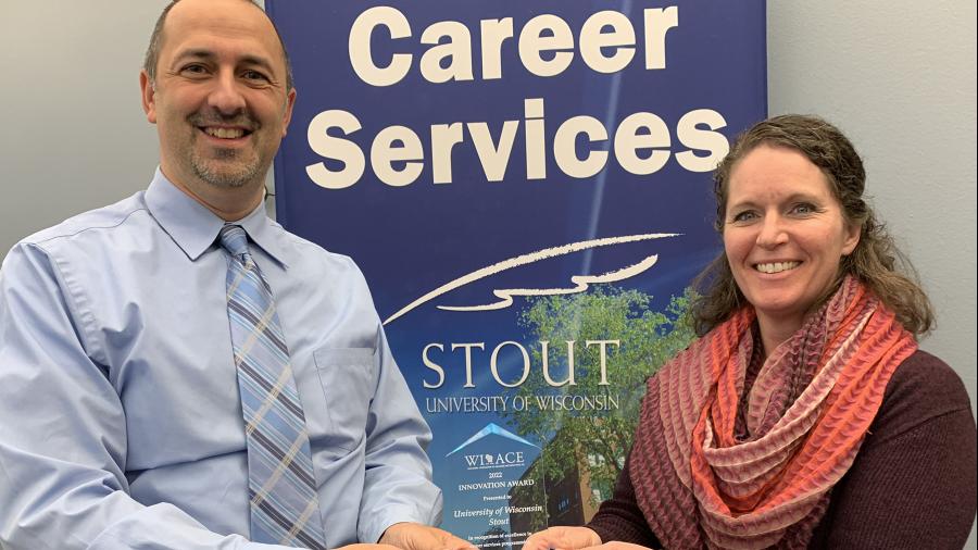UW-Stout Career Services Director Bryan Barts and Sara Anger, career development manager with Career Services, hold the Innovation Award from the Wisconsin Association of Colleges and Employers.
