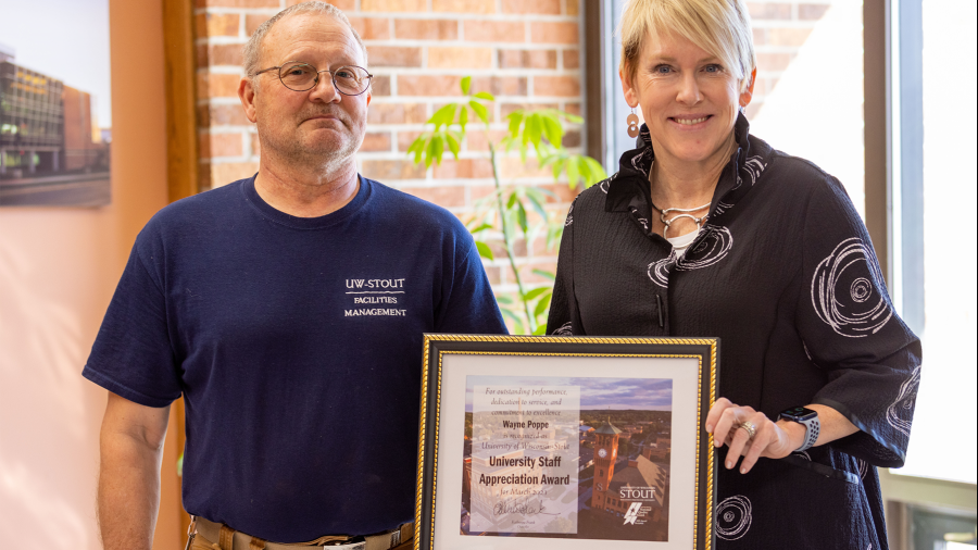 Wayne Poppe, left, receives the March University Staff Employee Appreciation award from Chancellor Katherine Frank.