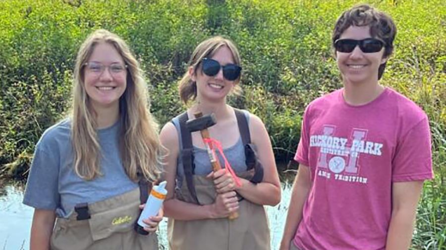 From left, Casie Kopischke of UW-Stout, Delaney Wormet of UW-Eau Claire and Kal Breeden of UW-Stout set up an experiment this summer measuring dissolved oxygen levels in Gilbert Creek as part of the Red Cedar Basin Watershed Monitoring project.