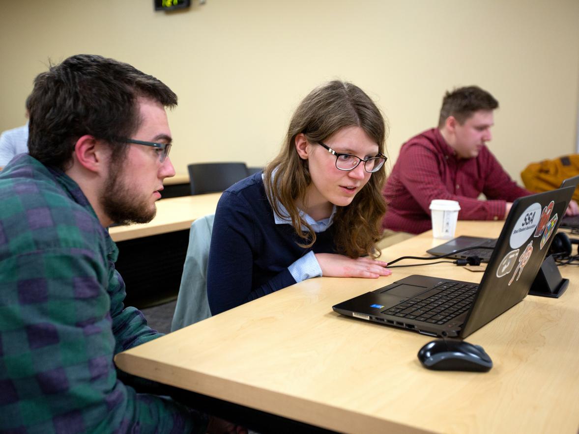 Student Erica Kelly goes over a problem with Assistant Professor Tyler Skorczewski in the Industrial Math class.