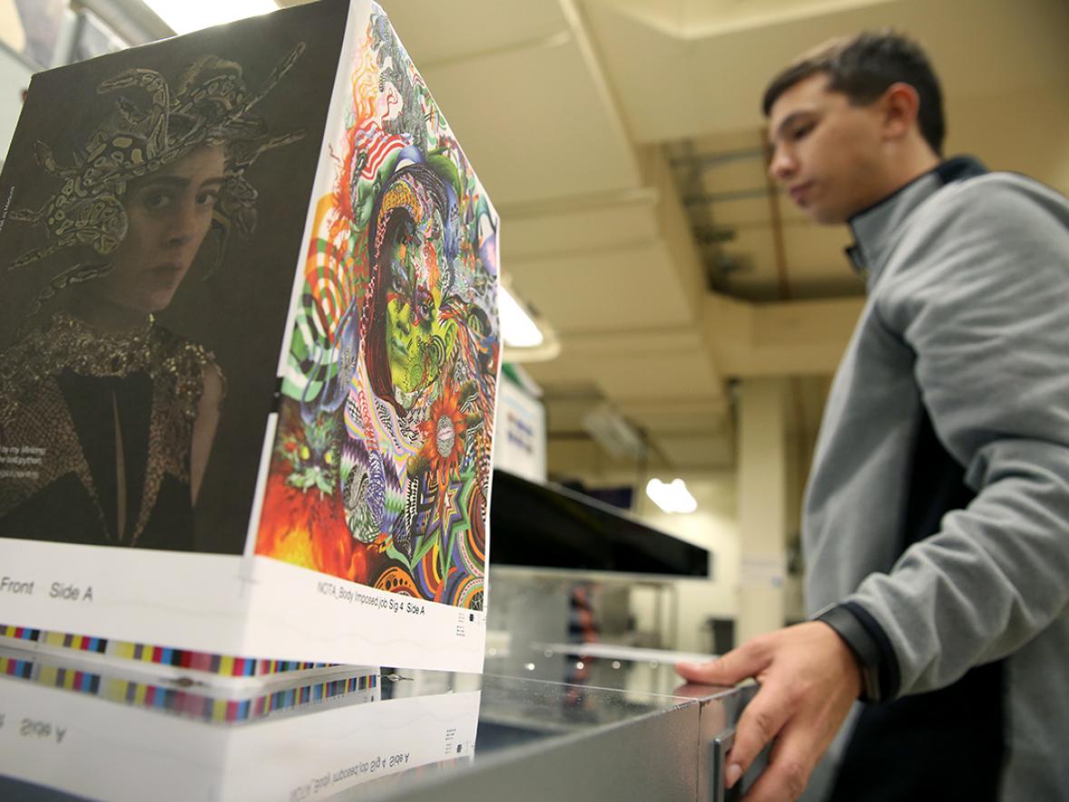 Students cut paper in a graphic communications lab at UW-Stout. A gift in kind to the department will allow students to work with the latest technologies for color management.