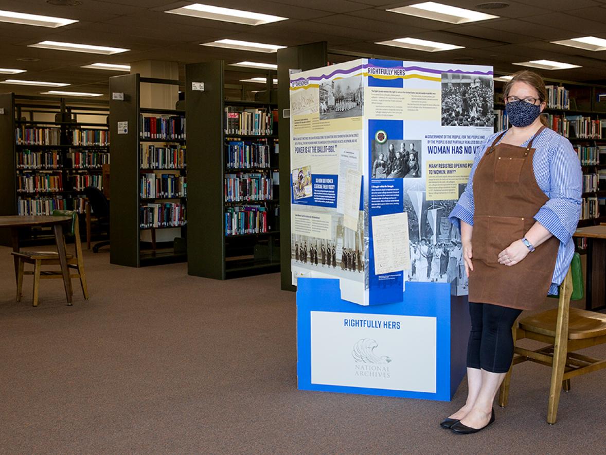 University Archivist Heather Stecklein with a National Archives exhibit in the UW-Stout library. Many UW-Stout women students strived to help pass the 19th amendment to the U.S. Constitution granting women the right to vote.