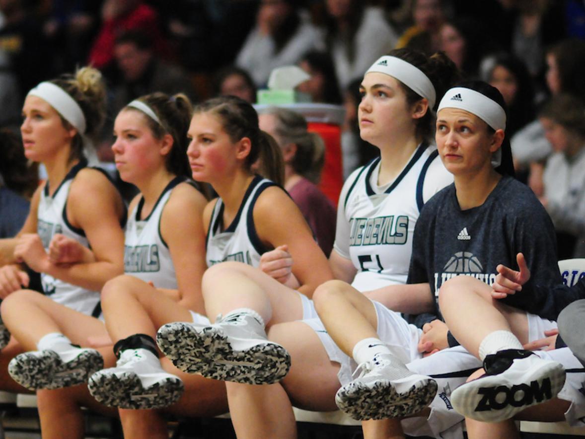 Erin O'Brien, #51, with her Women's Basketball team mates on the sidelines.