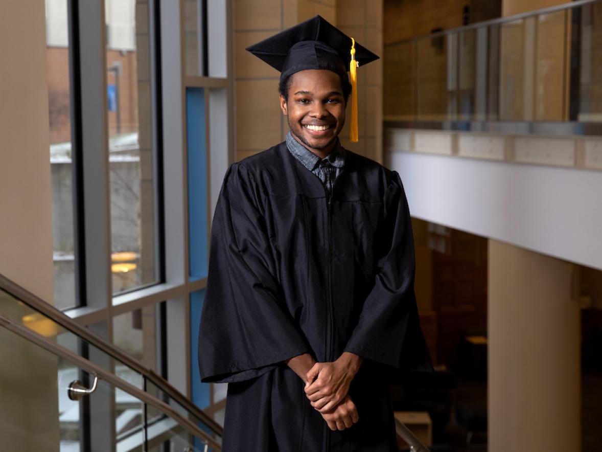 Deon Canon, double major graduate in professional communication and emerging media and applied social sciences, in the Memorial Student Center grand stairwell.