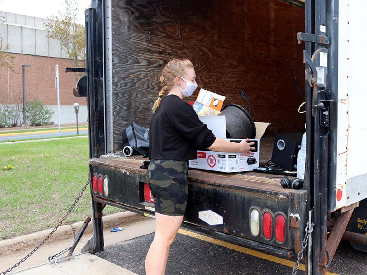 UW-Stout student Kaitlin Ingle delivers items to be recycled and reused at the Spring Move Out event held on campus.