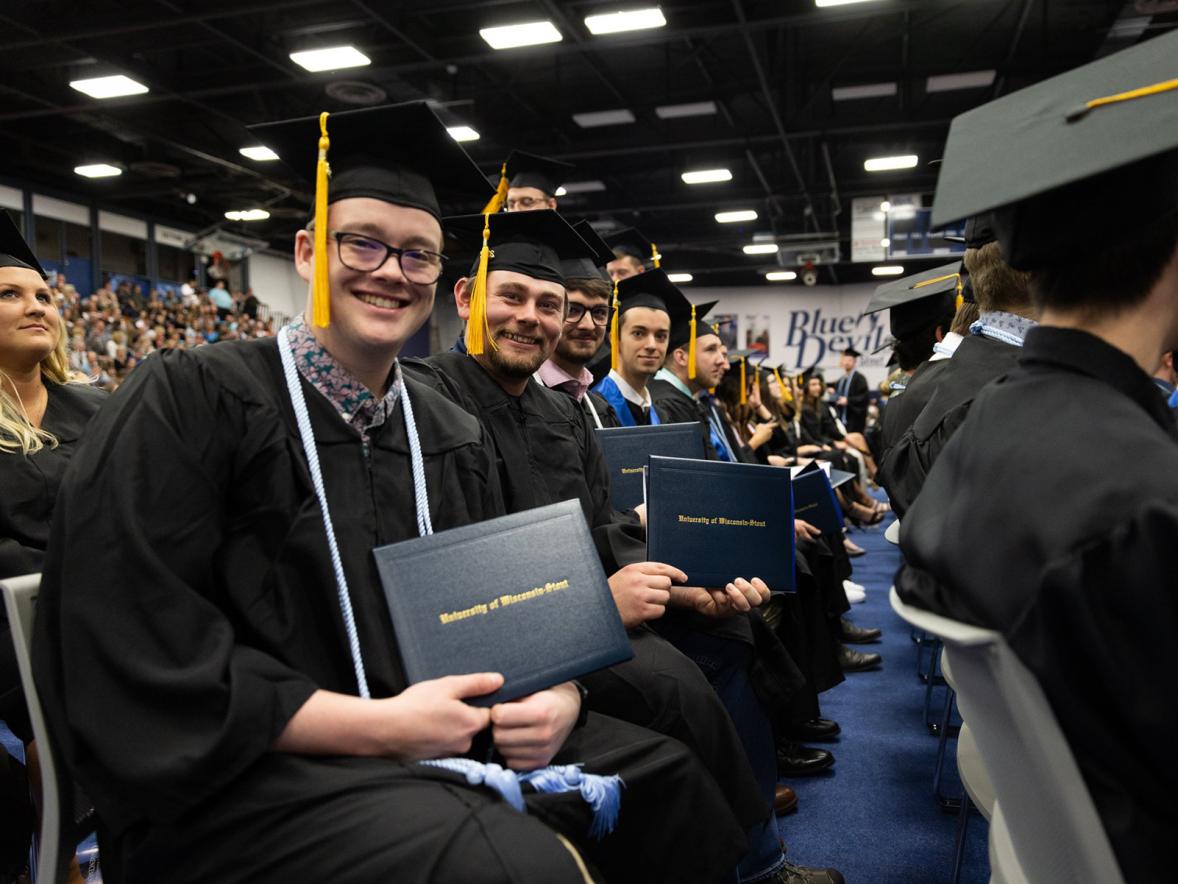 Graduates proudly show off their diplomas during one of the ceremonies at Johnson Fieldhouse.