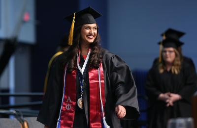 Asha Bahr, rehabilitation services graduate, crossing the stage at commencement, May 2018.