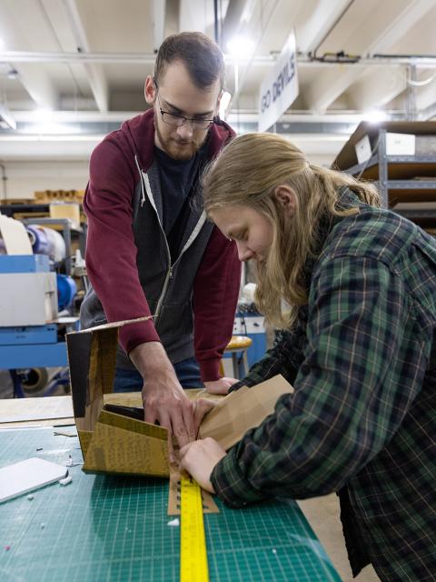 Connor Erwin and Megan Ongemach develop a package in a lab.